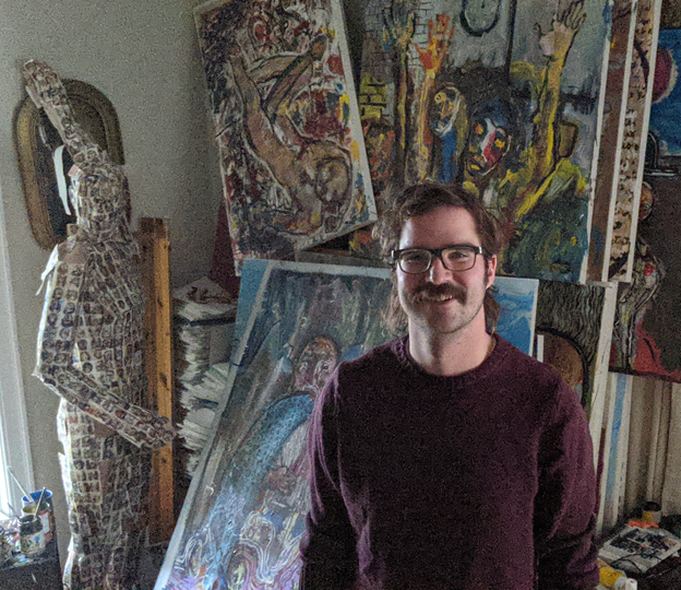 Tim Mikula with artwork in the background