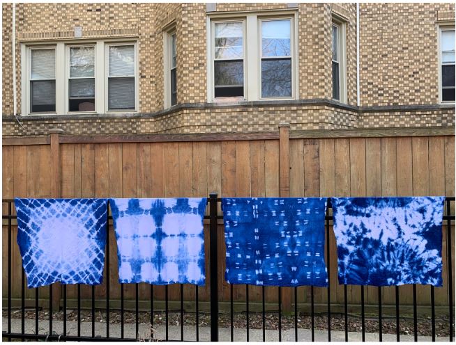 Shibori tea towel hanging on fence