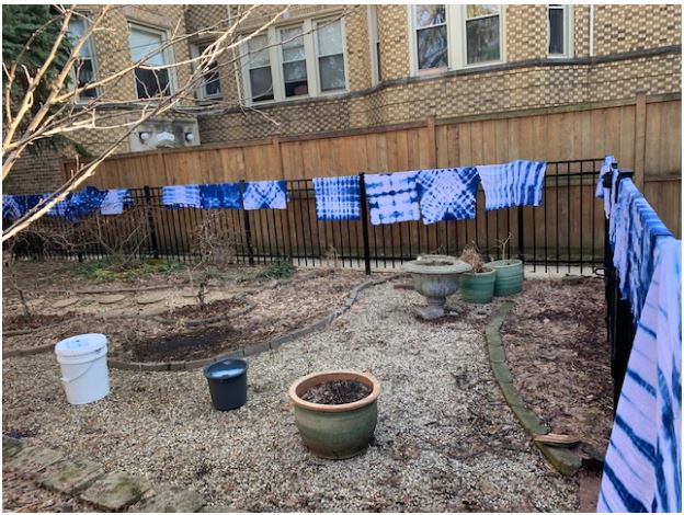 Shibori party finished products hanging on fence to dry