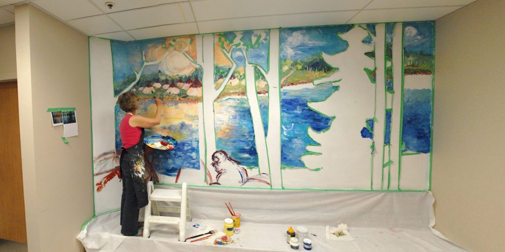 Artist Nancy Corrigan working on an interior mural